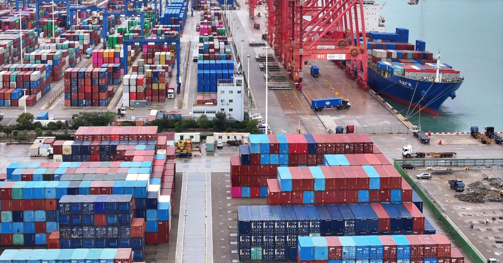 Container ships backed up at a major Chinese port amid Iran war-related supply chain disruption — the Strait of Hormuz closure stretched shipping times from 30 days to 50+ days and sent freight rates soaring