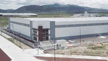 A manufacturing facility in Mexico's industrial corridor — nearshoring to Mexico has accelerated as USMCA zero-tariff treatment makes it the most cost-effective alternative to Chinese manufacturing for North American supply chains